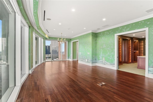 625 St Charles Ave Phd, Phd, New Orleans, LA 70130 - empty room featuring crown molding, wallpapered walls, a chandelier, wood finished floors, and recessed lighting