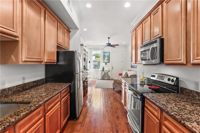 1210 Lyons St Unit 1210, New Orleans, LA 70115 - kitchen with appliances with stainless steel finishes, a ceiling fan, dark wood-style floors, recessed lighting, and brown cabinetry