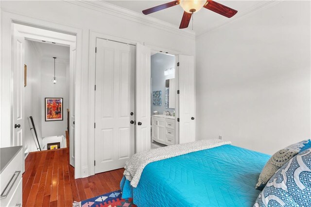 1210 Lyons St Unit 1210, New Orleans, LA 70115 - bedroom featuring ornamental molding, dark wood finished floors, a ceiling fan, connected bathroom, and a closet