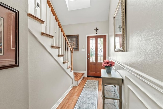 19199 Hector St, Mandeville, LA 70471 - entryway featuring light wood-style floors, a textured wall, and stairs