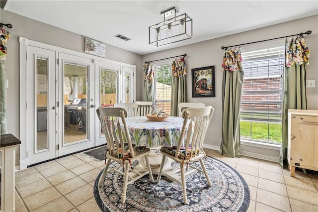 19199 Hector St, Mandeville, LA 70471 - dining room featuring french doors and light tile patterned floors