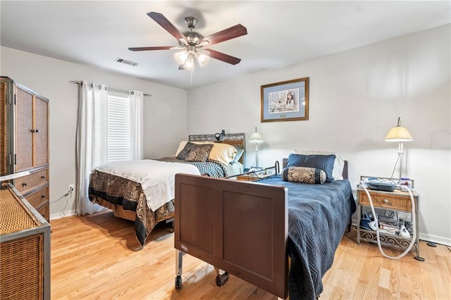 19199 Hector St, Mandeville, LA 70471 - bedroom with light wood finished floors and a ceiling fan
