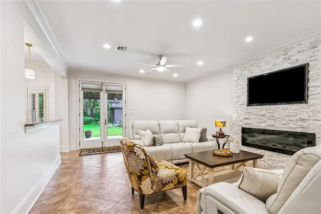 4917 Lake Vista Dr, Metairie, LA 70006 - living room with ornamental molding, a ceiling fan, a stone fireplace, recessed lighting, and tile patterned flooring