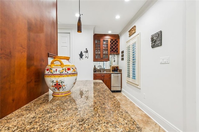 4917 Lake Vista Dr, Metairie, LA 70006 - kitchen with recessed lighting, glass insert cabinets, stone countertops, crown molding, and light tile patterned floors
