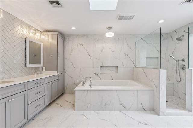 4917 Lake Vista Dr, Metairie, LA 70006 - bathroom featuring a bath, marble tiled flooring, vanity, a marble finish shower, and recessed lighting