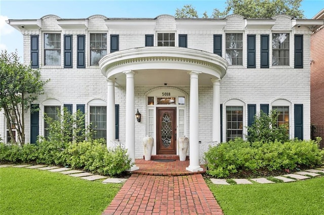 5018 St Charles Ave, New Orleans, LA 70115 - view of front facade featuring brick siding and a front lawn