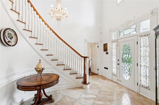 5018 St Charles Ave, New Orleans, LA 70115 - entryway featuring a towering ceiling, stairway, and a chandelier