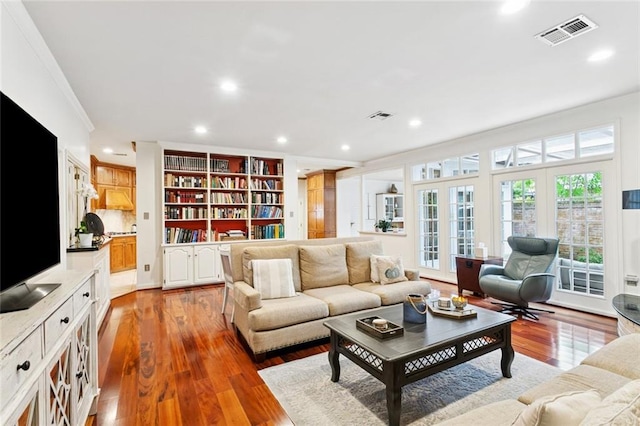 5018 St Charles Ave, New Orleans, LA 70115 - living room featuring wood finished floors, crown molding, and recessed lighting