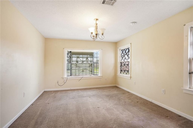 4124 Eve St, New Orleans, LA 70125 - unfurnished room with carpet, a chandelier, and a textured ceiling