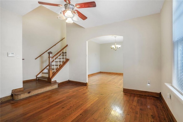 4124 Eve St, New Orleans, LA 70125 - empty room with arched walkways, ceiling fan, stairs, a chandelier, and hardwood / wood-style flooring