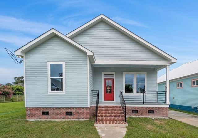 1908 Benjamin St, Arabi, LA 70032 - view of front of home with crawl space, covered porch, and a front yard