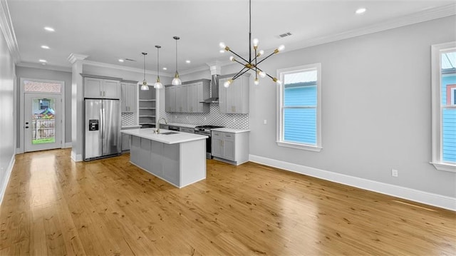 1908 Benjamin St, Arabi, LA 70032 - kitchen featuring appliances with stainless steel finishes, gray cabinetry, wall chimney exhaust hood, light countertops, and recessed lighting