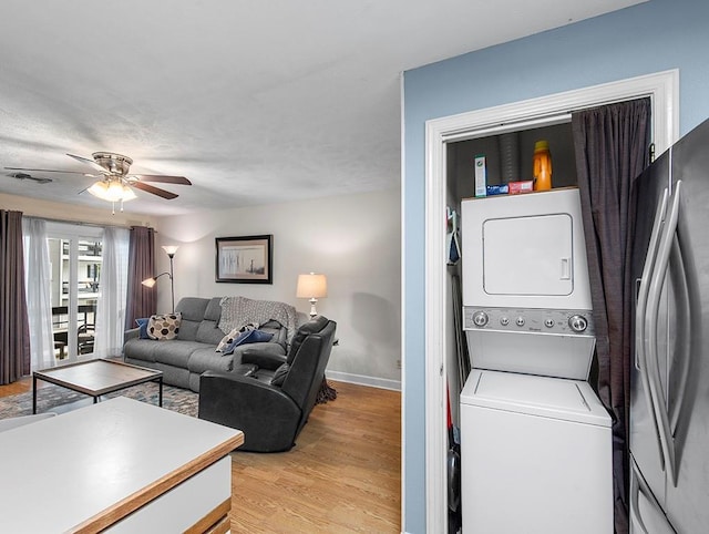 420 Metairie Hammond Hwy Unit 225, Metairie, LA 70005 - laundry room featuring stacked washer / dryer, a ceiling fan, and light wood finished floors