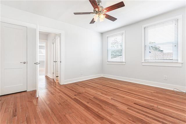 694244 Canal Blvd, New Orleans, LA 70115 - empty room with light wood-style flooring and a ceiling fan