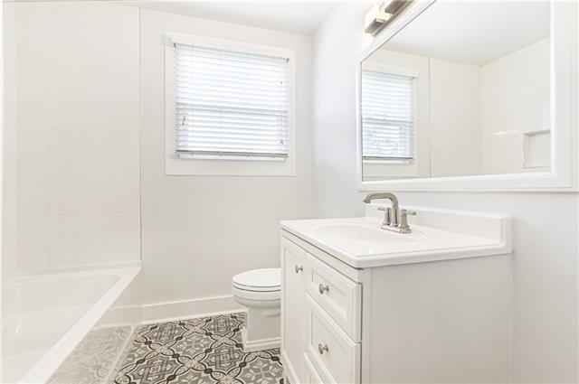694244 Canal Blvd, New Orleans, LA 70115 - bathroom featuring vanity, tile patterned floors, and bathtub / shower combination