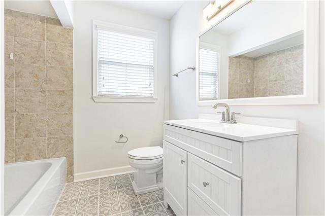 694244 Canal Blvd, New Orleans, LA 70115 - bathroom featuring vanity and tile patterned flooring
