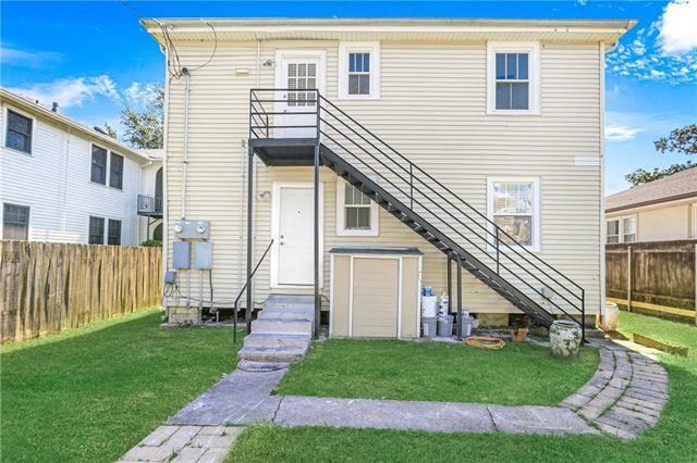 694244 Canal Blvd, New Orleans, LA 70115 - back of house featuring stairway and a fenced backyard