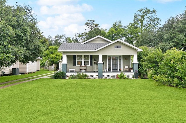106 Rowley Blvd, La Place, LA 70068 - view of front facade featuring covered porch, a front lawn, and a shingled roof