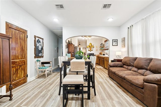 106 Rowley Blvd, La Place, LA 70068 - dining space featuring arched walkways, light wood finished floors, and recessed lighting