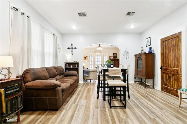 106 Rowley Blvd, La Place, LA 70068 - living room featuring arched walkways and light wood finished floors