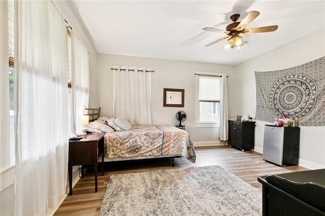 106 Rowley Blvd, La Place, LA 70068 - bedroom with light wood finished floors, freestanding refrigerator, and a ceiling fan