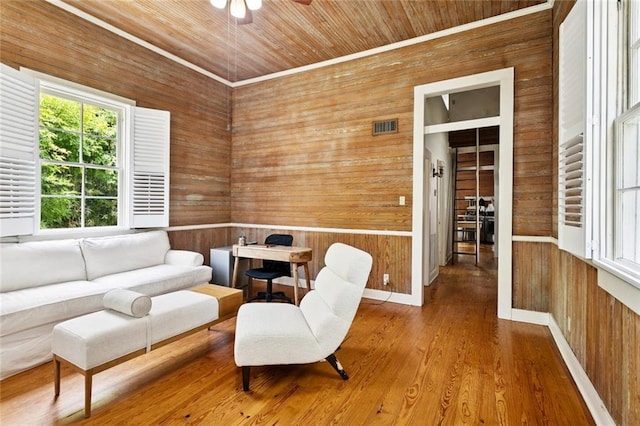 2027 Monroe St, Mandeville, LA 70448 - sitting room with wood walls, wood ceiling, ceiling fan, and wood finished floors