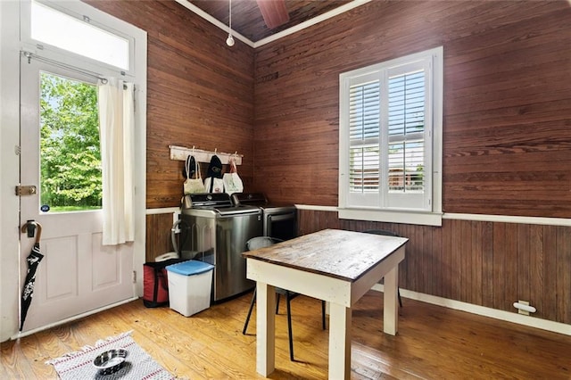2027 Monroe St, Mandeville, LA 70448 - interior space with washing machine and dryer, wood walls, and light wood-type flooring