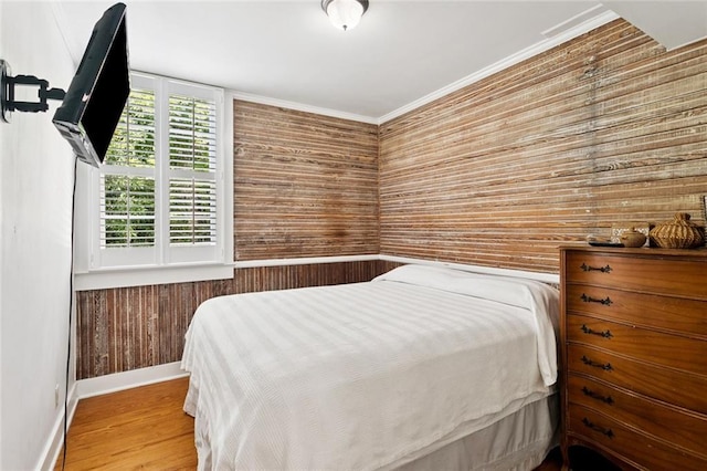 2027 Monroe St, Mandeville, LA 70448 - bedroom featuring wooden walls, wood finished floors, and crown molding