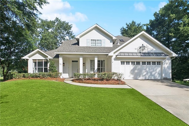 35 Elmwood Loop, Madisonville, LA 70447 - view of front of house featuring a garage, a front yard, roof with shingles, driveway, and a standing seam roof