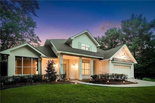 35 Elmwood Loop, Madisonville, LA 70447 - view of front of home featuring a front lawn, brick siding, an attached garage, and a shingled roof