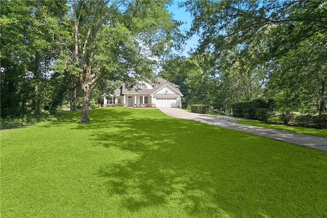 35 Elmwood Loop, Madisonville, LA 70447 - view of front facade with concrete driveway, a front yard, and a garage