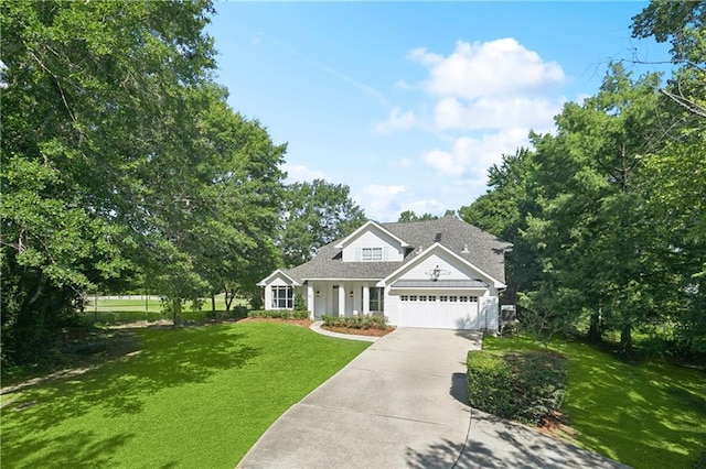 35 Elmwood Loop, Madisonville, LA 70447 - traditional-style home with a front lawn, concrete driveway, a garage, and roof with shingles