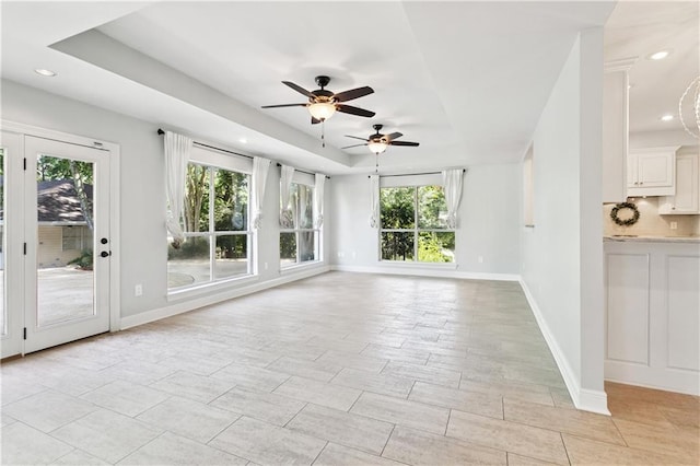 35 Elmwood Loop, Madisonville, LA 70447 - unfurnished living room featuring a ceiling fan, a tray ceiling, and recessed lighting
