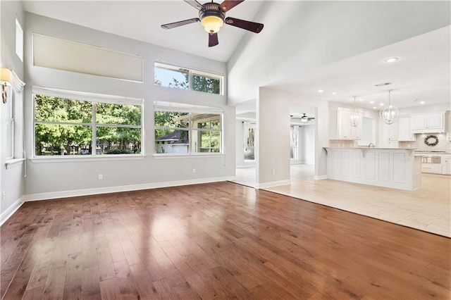 35 Elmwood Loop, Madisonville, LA 70447 - unfurnished living room featuring ceiling fan, light wood-style flooring, a chandelier, and recessed lighting