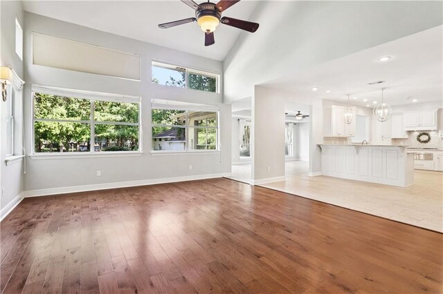 35 Elmwood Loop, Madisonville, LA 70447 - unfurnished living room featuring ceiling fan, light wood-style flooring, a chandelier, and recessed lighting