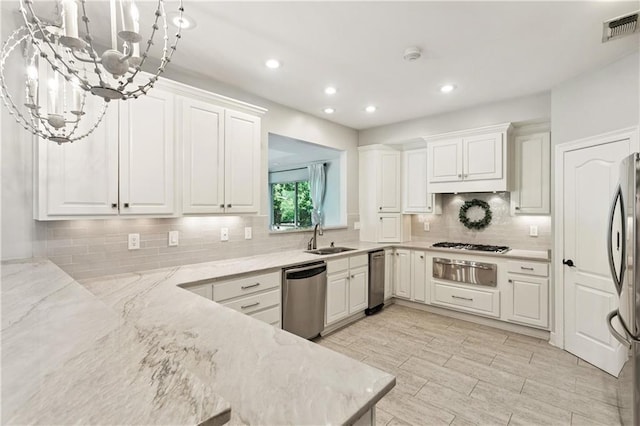 35 Elmwood Loop, Madisonville, LA 70447 - kitchen featuring stainless steel appliances, a warming drawer, recessed lighting, white cabinets, and backsplash