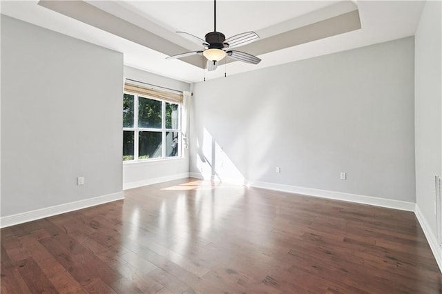 35 Elmwood Loop, Madisonville, LA 70447 - unfurnished room with wood finished floors, a tray ceiling, and ceiling fan