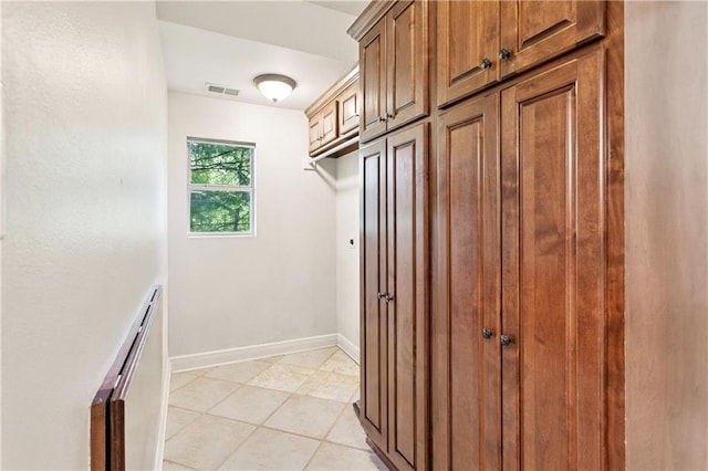 35 Elmwood Loop, Madisonville, LA 70447 - laundry room featuring baseboards and light tile patterned floors