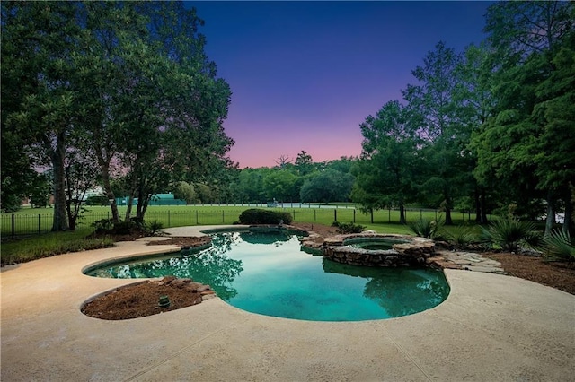 35 Elmwood Loop, Madisonville, LA 70447 - pool at dusk featuring a patio area and a pool with connected hot tub