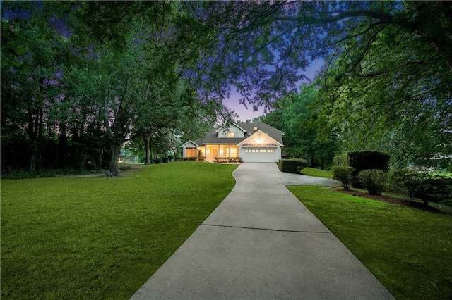 35 Elmwood Loop, Madisonville, LA 70447 - view of front facade featuring concrete driveway, a yard, and an attached garage