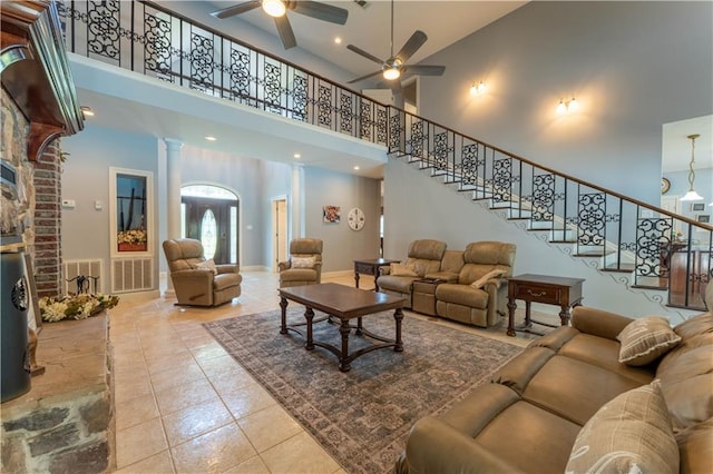 31 Allen Hill Rd, Tylertown, MS 39667 - tiled living area featuring a towering ceiling, ceiling fan, stairway, ornate columns, and a brick fireplace