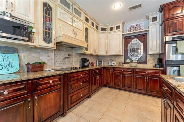 31 Allen Hill Rd, Tylertown, MS 39667 - kitchen featuring stainless steel appliances, tasteful backsplash, light tile patterned flooring, glass insert cabinets, and light stone countertops