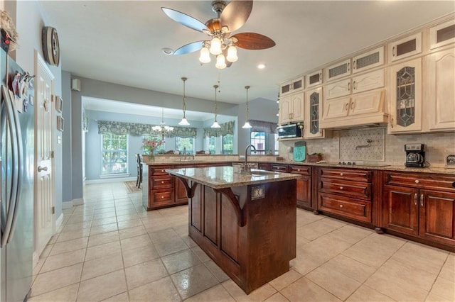 31 Allen Hill Rd, Tylertown, MS 39667 - kitchen featuring a peninsula, a ceiling fan, backsplash, appliances with stainless steel finishes, and cream cabinetry