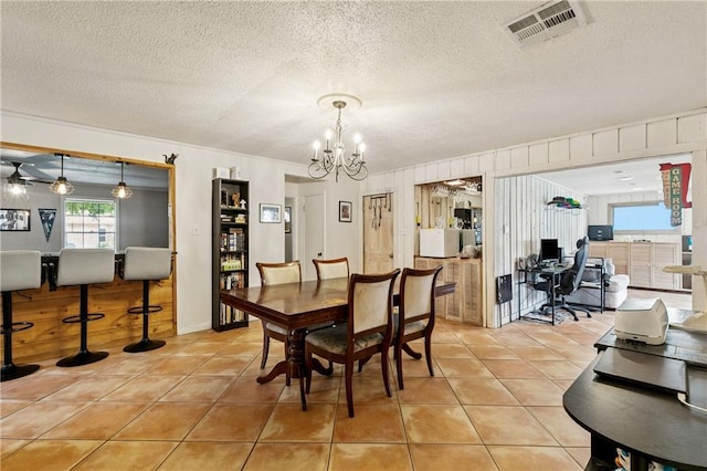 2041 Glencove Ln, Terrytown, LA 70056 - dining room featuring a chandelier, an office area, light tile patterned flooring, a textured ceiling, and crown molding