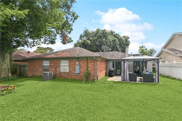 2041 Glencove Ln, Terrytown, LA 70056 - back of property with a gazebo, an outdoor living space, a fenced backyard, brick siding, and a patio