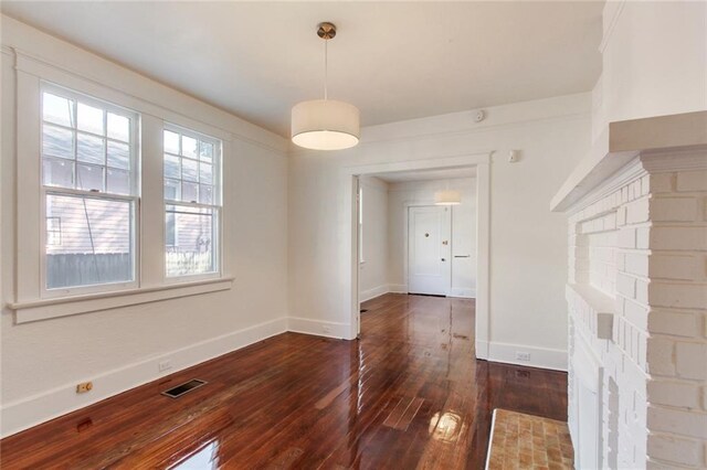 5227-29 Coliseum St, New Orleans, LA 70115 - unfurnished dining area featuring dark wood-type flooring and baseboards