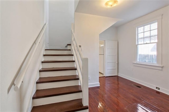 5227-29 Coliseum St, New Orleans, LA 70115 - staircase featuring healthy amount of natural light and wood finished floors