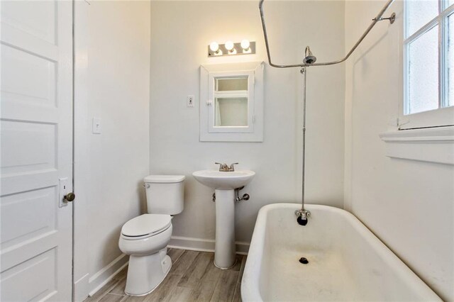 5227-29 Coliseum St, New Orleans, LA 70115 - bathroom featuring a soaking tub and wood finished floors