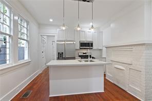 5227-29 Coliseum St, New Orleans, LA 70115 - kitchen with appliances with stainless steel finishes, white cabinetry, light countertops, dark wood-style floors, and recessed lighting