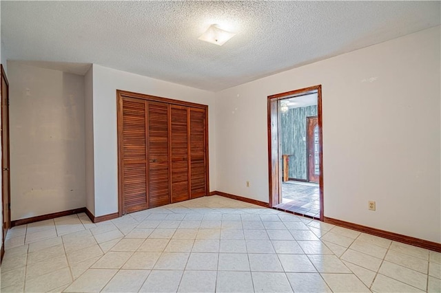 210 Lake Ontario Ct, Slidell, LA 70461 - unfurnished bedroom featuring a textured ceiling, a closet, and light tile patterned floors